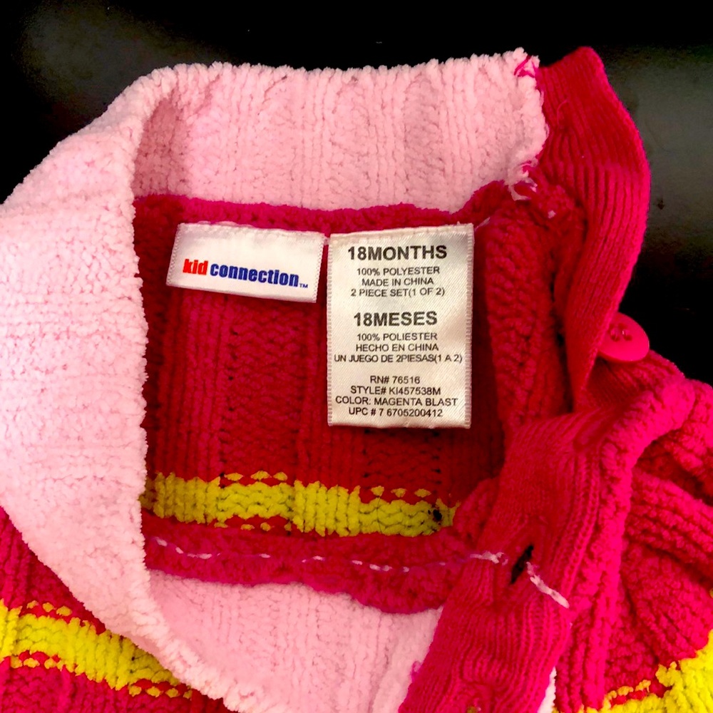 Very colorful warm knitted sweater. Two buttons on side of neck. Long sleeve.